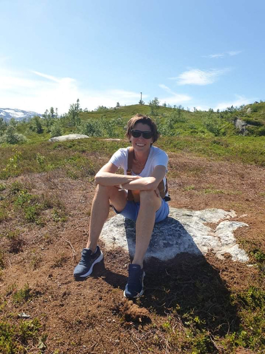 portrett av Elisabeth Aksnes som sitter på en stein ute i naturen